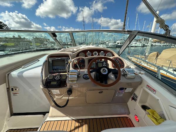 Slide: The Image of 2004 Sea Ray 320 Sundancer helm with marina view. - 20