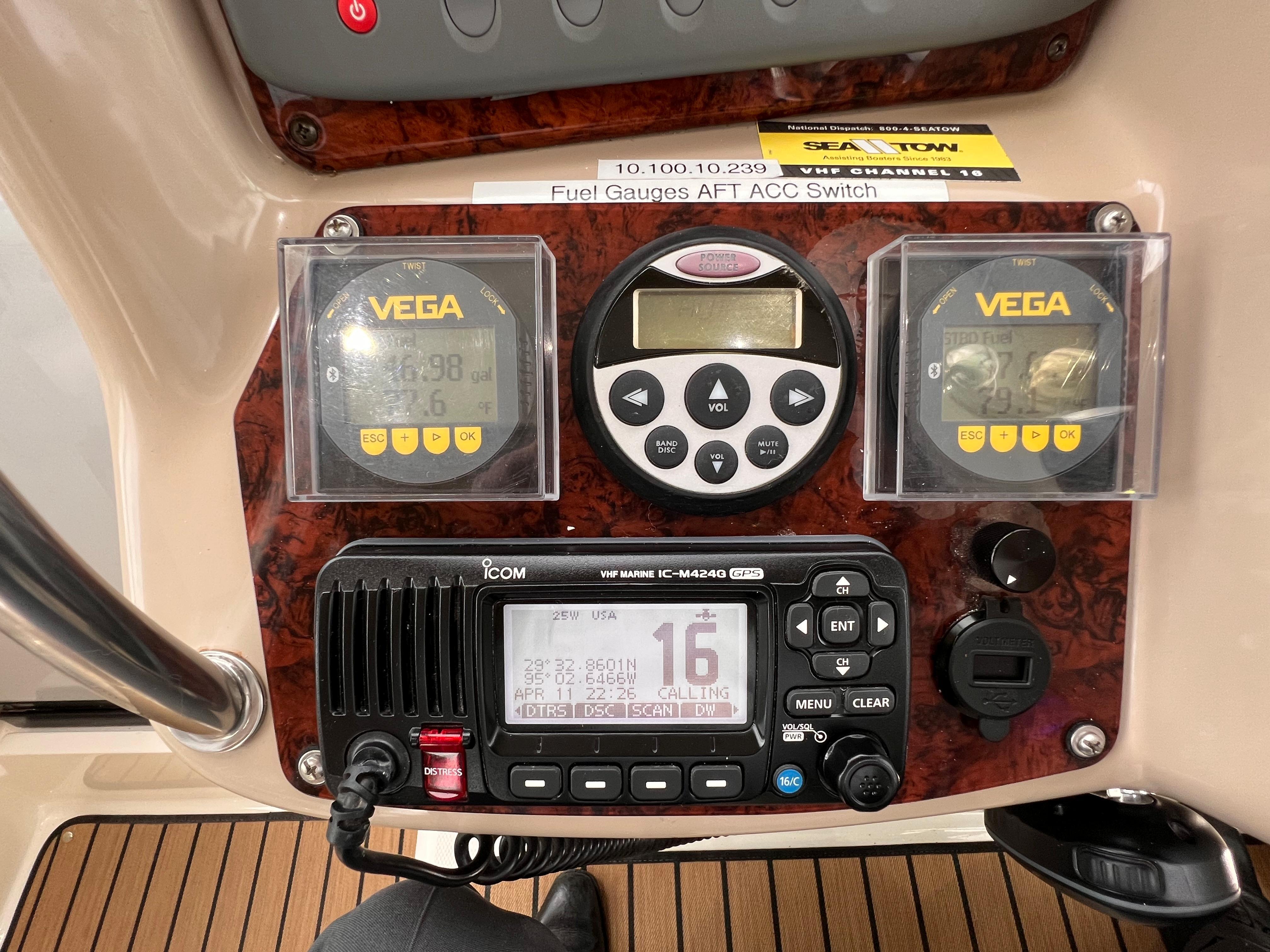 Slide: The Image of Control panel of a 2004 Sea Ray 320 Sundancer with Vega gauges and Icom VHF radio. - 24