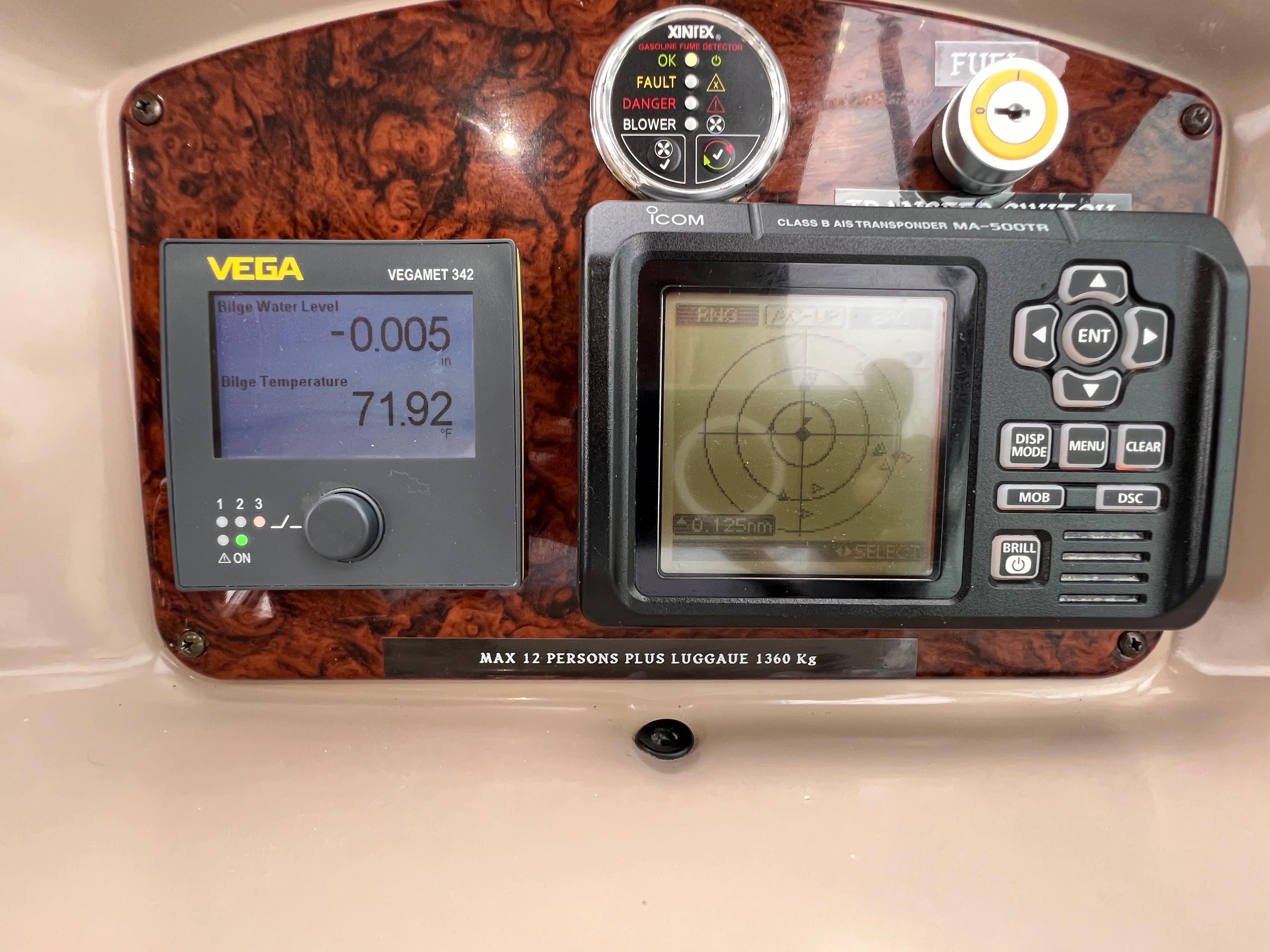 Slide: The Image of Control panel of a 2004 Sea Ray 320 Sundancer boat with Vega and Icom displays. - 26