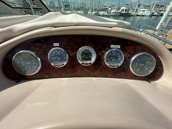 Slide: The Image of Dashboard of a 2004 Sea Ray 320 Sundancer boat with gauges. - 27