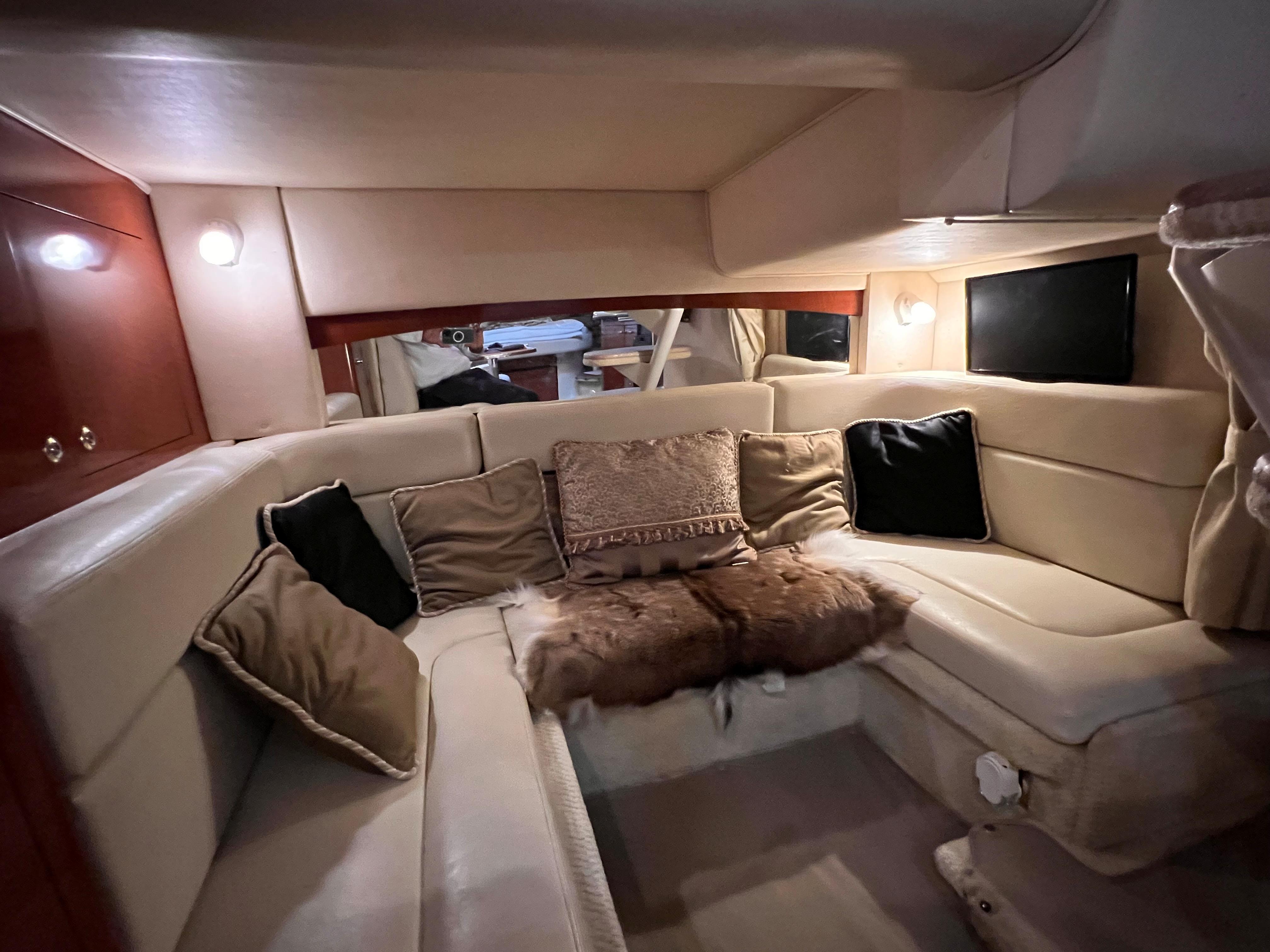 Slide: The Image of Luxurious interior of 2004 Sea Ray 320 Sundancer with plush seating and ambient lighting. - 32