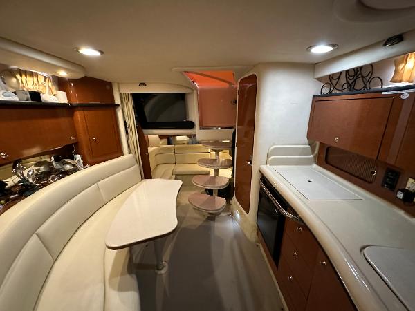 Slide: The Image of Interior of 2004 Sea Ray 320 Sundancer yacht with modern kitchen and seating area. - 37