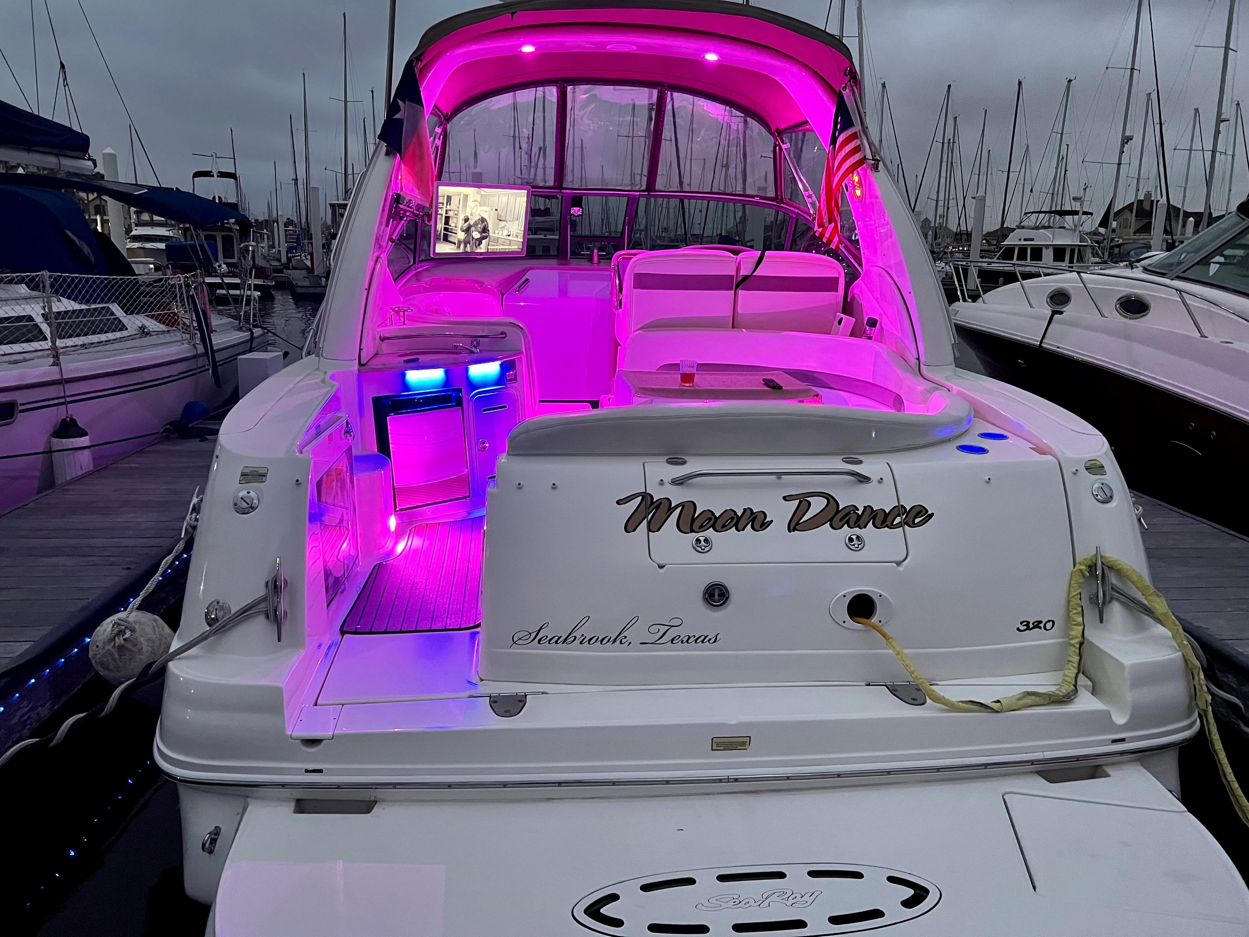 Slide: The Image of 2004 Sea Ray 320 Sundancer yacht with pink interior lighting docked at marina. - 8