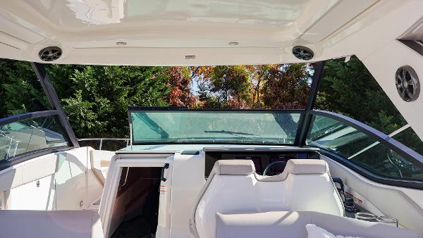 Slide: The Image of Interior view of 2021 Sea Ray 320 Sundancer boat with seating and open cabin. - 10