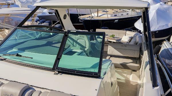 Slide: The Image of 2021 Sea Ray 320 Sundancer boat with sleek design and spacious seating. - 11