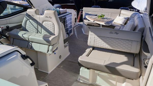 Slide: The Image of Luxurious 2021 Sea Ray 320 Sundancer interior with plush seating and elegant design. - 12