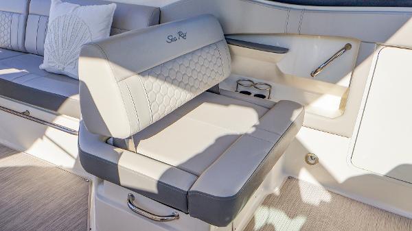 Slide: The Image of Luxurious seating on 2021 Sea Ray 320 Sundancer boat with elegant upholstery and cup holders. - 22