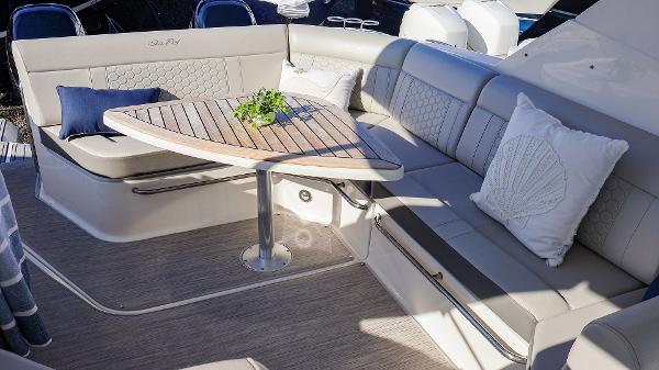 Slide: The Image of Luxurious seating area on 2021 Sea Ray 320 Sundancer yacht with elegant cushions and table. - 25