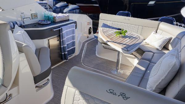 Slide: The Image of Luxurious interior of 2021 Sea Ray 320 Sundancer yacht with elegant seating and table. - 26