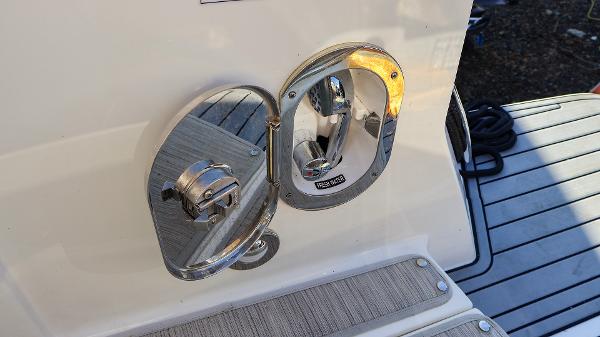 Slide: The Image of 2021 Sea Ray 320 Sundancer fuel cap on deck, stainless steel finish. - 30