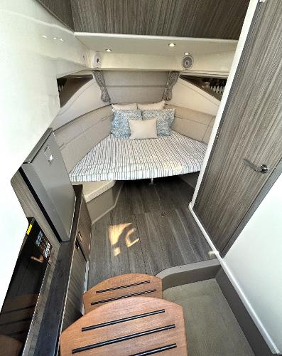 Slide: The Image of Interior cabin of 2021 Sea Ray 320 Sundancer with bed and kitchenette. - 31