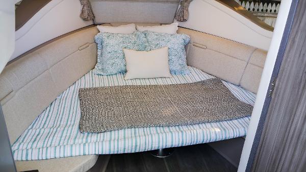 Slide: The Image of Cozy cabin interior of 2021 Sea Ray 320 Sundancer with plush bedding. - 33