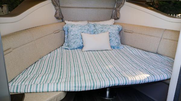 Slide: The Image of 2021 Sea Ray 320 Sundancer cabin with cozy bedding and pillows. - 34