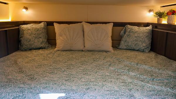Slide: The Image of Cozy cabin interior of 2021 Sea Ray 320 Sundancer with decorative pillows and soft lighting. - 39
