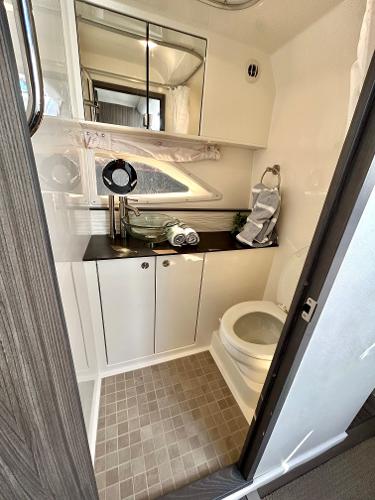 Slide: The Image of 2021 Sea Ray 320 Sundancer bathroom with modern fixtures and ample storage. - 44