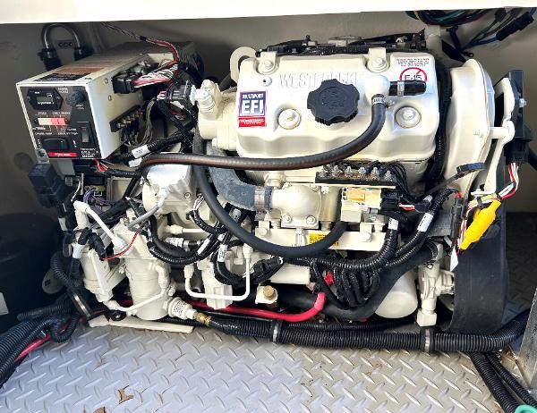 Slide: The Image of 2021 Sea Ray 320 Sundancer engine compartment with Westerbeke generator and electronic fuel injection system. - 47
