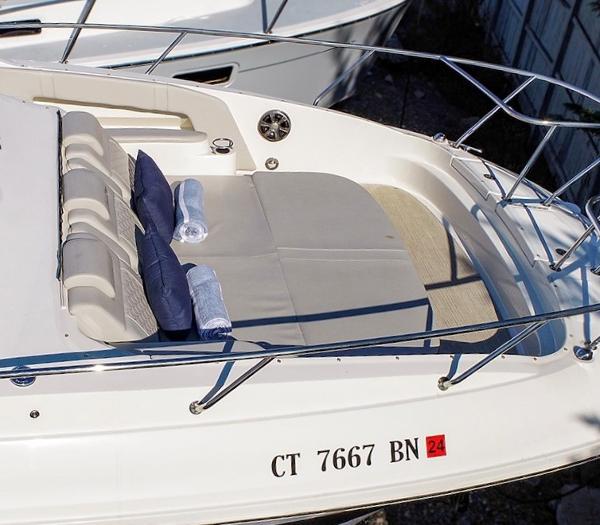 Slide: The Image of 2021 Sea Ray 320 Sundancer boat with cushioned seating and towels. - 8