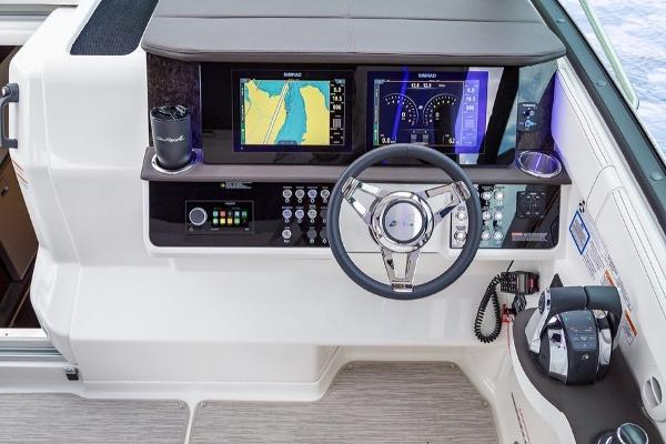 Slide: The Image of 2023 Sea Ray Sundancer 320 helm with advanced navigation and control systems. - 13