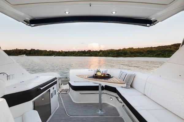 Slide: The Image of Sea Ray Sundancer 320 2023 boat interior with lake view and sunset. - 14