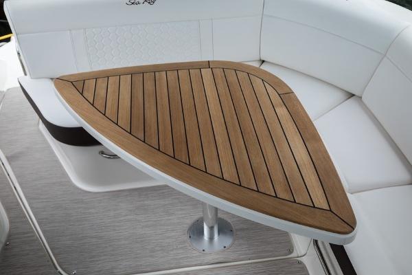 Slide: The Image of Sea Ray Sundancer 320 2023 interior with wooden table and white seating. - 16