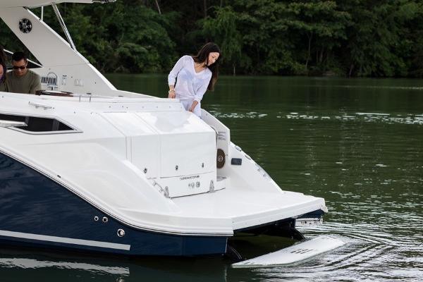Slide: The Image of 2023 Sea Ray Sundancer 320 yacht with people enjoying the water. - 18