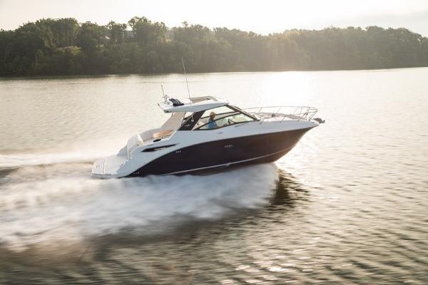 Slide: The Image of 2023 Sea Ray Sundancer 320 cruising on a serene lake. - 2