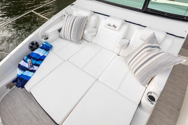 Slide: The Image of Luxurious seating area on 2023 Sea Ray Sundancer 320 boat with cushions and striped pillows. - 20