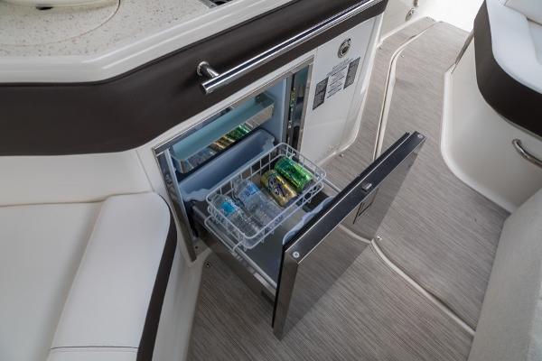 Slide: The Image of Sea Ray Sundancer 320 2023 boat interior with open mini fridge. - 21