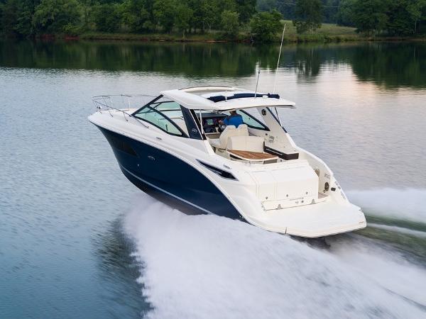 Slide: The Image of 2023 Sea Ray Sundancer 320 cruising on a serene lake. - 4