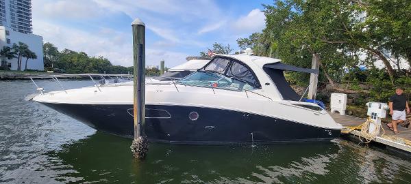 Slide: The Image of 2008 Sea Ray 350 Sundancer docked by the water. - 0
