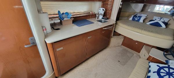 Slide: The Image of Interior of 2008 Sea Ray 350 Sundancer with kitchenette and cozy sleeping area. - 22