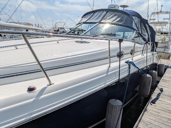 Slide: The Image of 2004 Sea Ray 360 Sundancer yacht docked at marina under clear sky. - 5