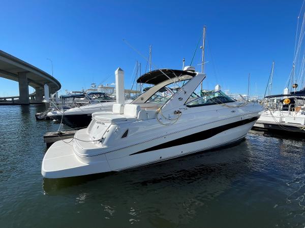 Slide: The Image of 2015 Sea Ray 370 Venture yacht docked in marina under clear blue sky. - 0