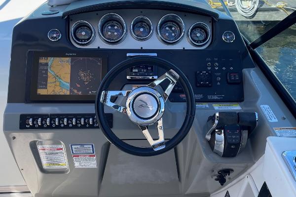 Slide: The Image of 2015 Sea Ray 370 Venture boat dashboard with navigation system and controls. - 14