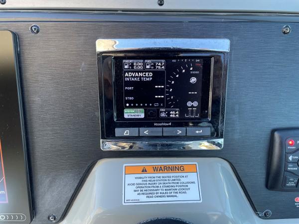Slide: The Image of 2015 Sea Ray 370 Venture dashboard with VesselView display and warning label. - 18