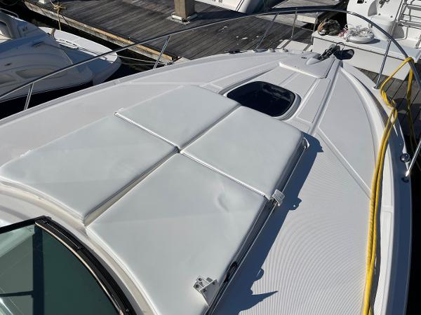 Slide: The Image of 2015 Sea Ray 370 Venture boat deck with sun pads and hatch. - 22