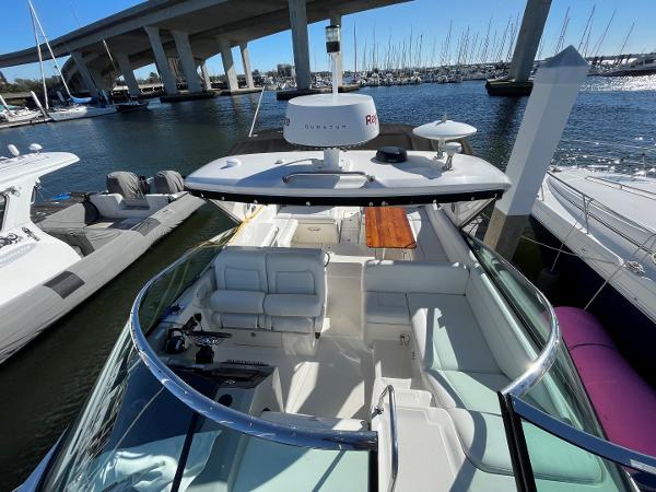 Slide: The Image of 2015 Sea Ray 370 Venture yacht docked at marina, under bridge, with clear sky. - 24