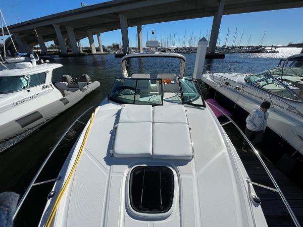 Slide: The Image of 2015 Sea Ray 370 Venture docked at marina with bridge in background. - 25