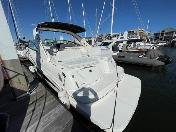 Slide: The Image of 2015 Sea Ray 370 Venture docked at marina with other boats. - 3