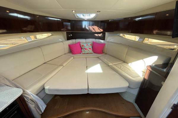 Slide: The Image of Luxurious 2015 Sea Ray 370 Venture cabin with plush seating and vibrant pillows. - 30