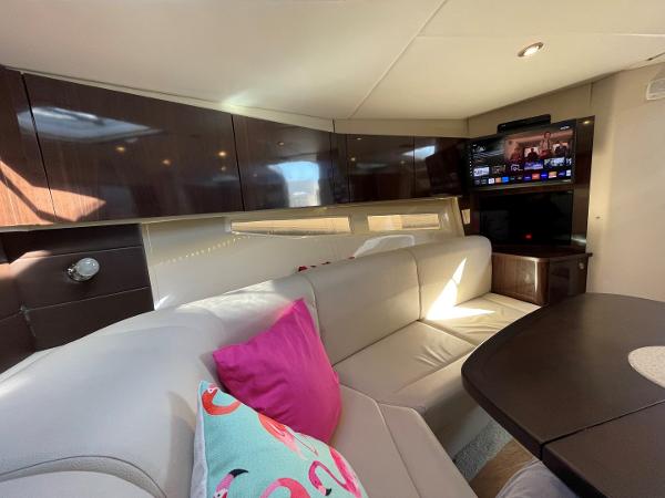 Slide: The Image of Interior of 2015 Sea Ray 370 Venture with modern seating and entertainment system. - 31