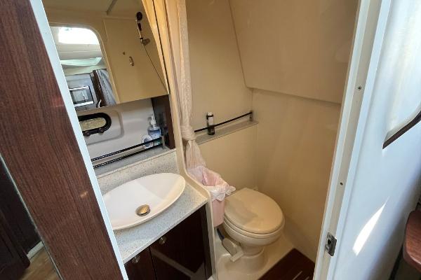 Slide: The Image of 2015 Sea Ray 370 Venture bathroom with sink, toilet, and mirror. - 39