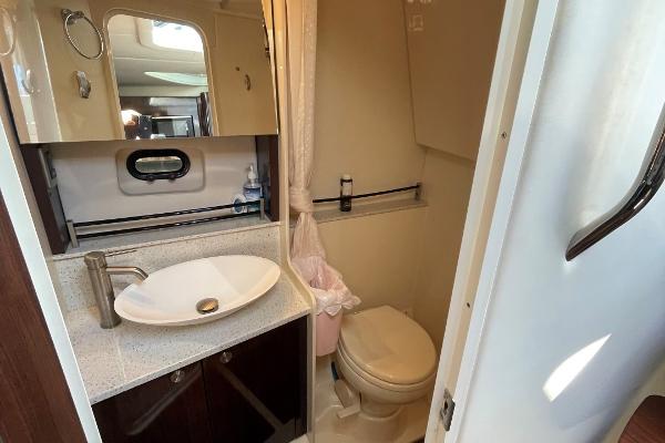 Slide: The Image of 2015 Sea Ray 370 Venture bathroom with sink, mirror, and toilet. - 40