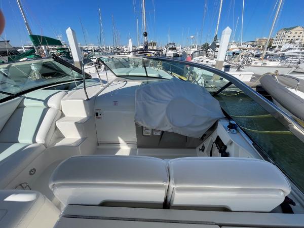 Slide: The Image of 2015 Sea Ray 370 Venture boat interior at a marina with clear blue sky. - 7