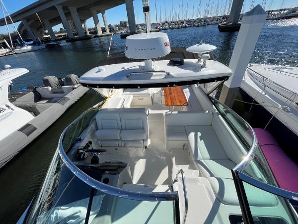 Slide: The Image of 2015 Sea Ray 370 Venture yacht docked at marina, spacious seating area. - 8