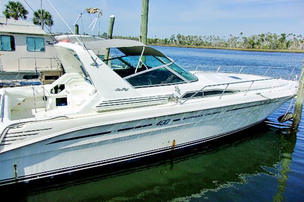 Slide: The Image of 1992 Sea Ray 400 Express Cruiser docked in a marina. - 1