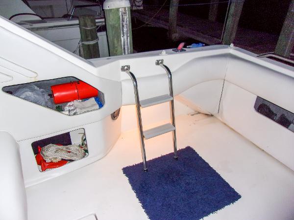 Slide: The Image of 1992 Sea Ray 400 Express Cruiser interior with ladder and storage compartments. - 11