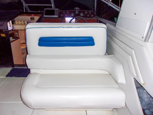 Slide: The Image of 1992 Sea Ray 400 Express Cruiser interior with white and blue seating. - 8