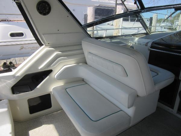 Slide: The Image of Interior seating of 1995 Sea Ray 400 Express Cruiser with white upholstery. - 16
