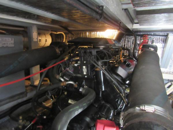 Slide: The Image of Engine compartment of a 1995 Sea Ray 400 Express Cruiser, showcasing mechanical components and wiring. - 42